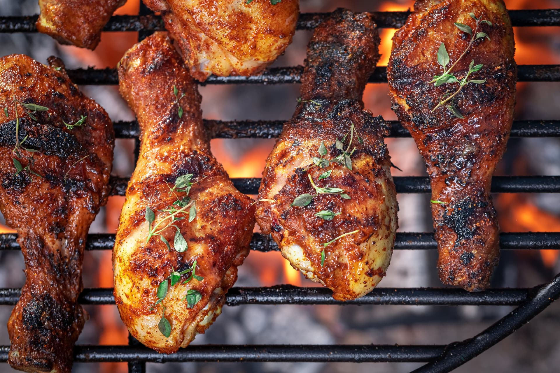 Spiced chicken drumsticks with thyme on the grill