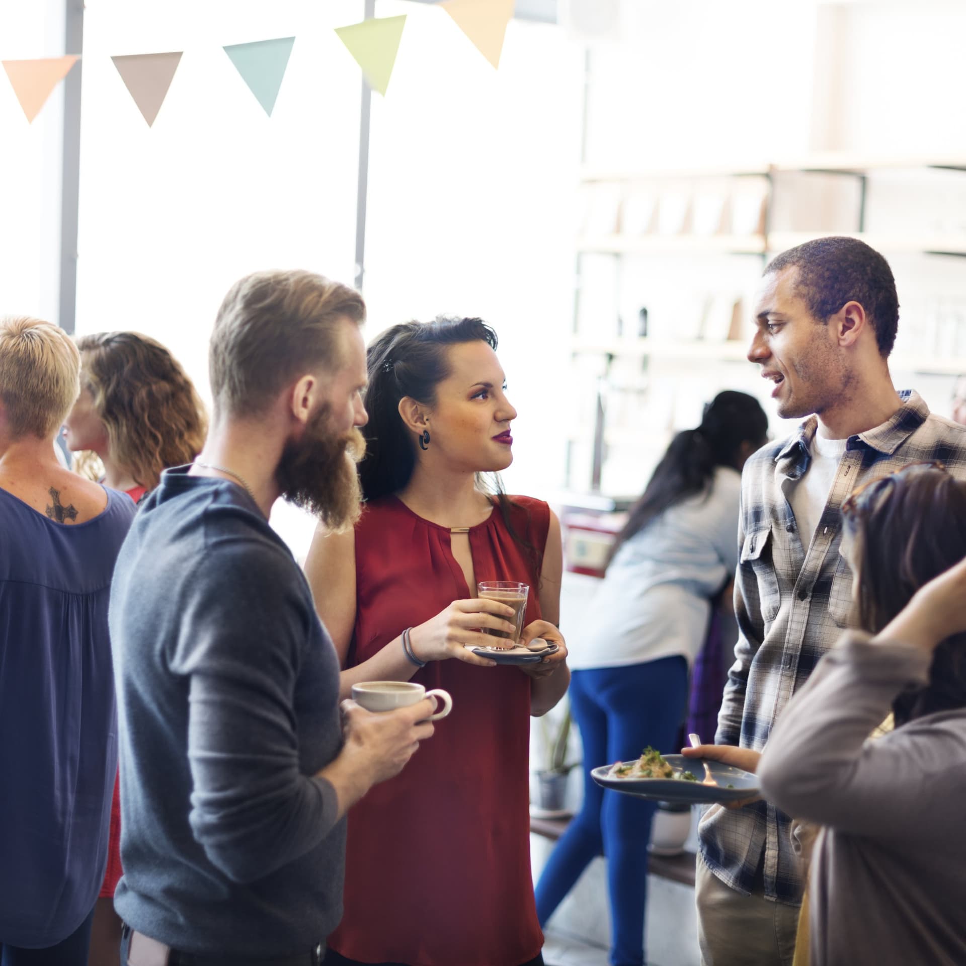 Colleagues chatting over food and drinks at a company event